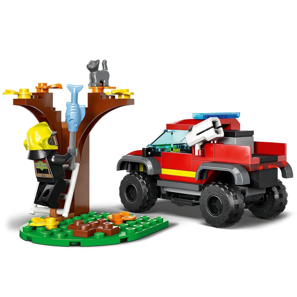 Image shows the lego figure on the ladder to lure the lego cat out of the tree with a fish on a stick