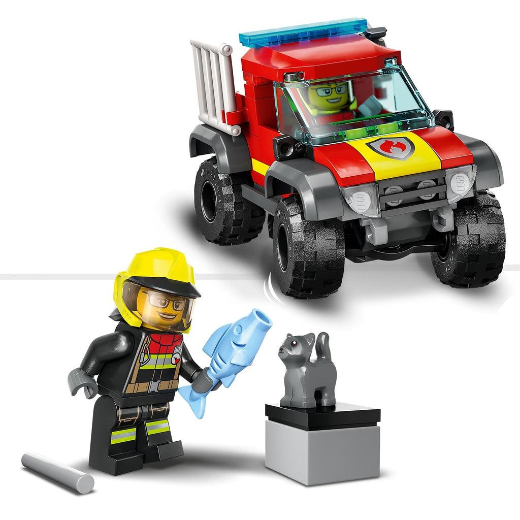 top shows the lego firefighter figure in the trucks driver seat | bottom image shows the figure holding a lego fish out to the cat