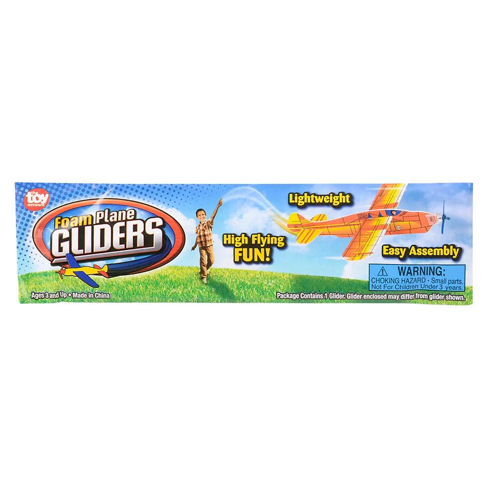 The packaging for the glider displays a boy throwing a glider which is large and close flying past. Text reads: Foam plane gliders, High flying fun!, lightweight, and easy assembly.