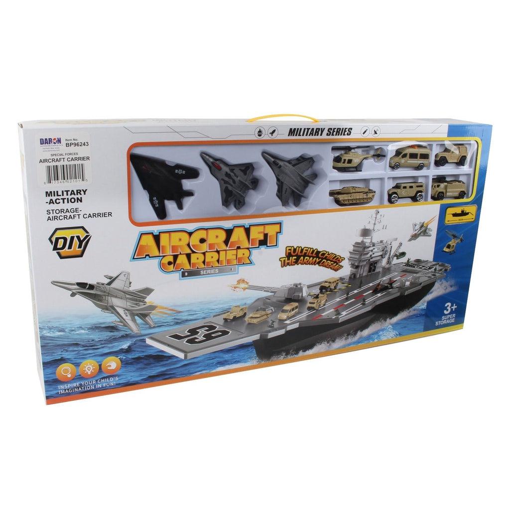 A wide box with a handle on top reads: Military-action Storage-Aircraft carrier DIY. Aircraft carrier series, fulfill childs army dreams! picture on box shows aircraft carrier with multiple cars on deck and 2 jets, one taking off and one about to land. Window at top of the box shows 3 plastic jets, a helicopter, a tank, and 3 various styles of trucks.