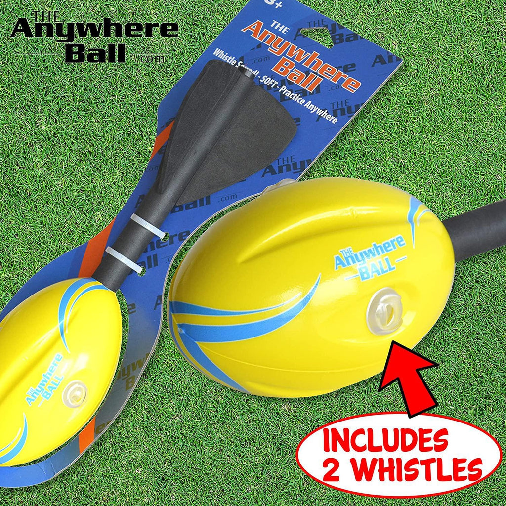 2 anywhere whistle footballs are shows in front of turf (fake grass for a football field). One is in packaging the other is not. A red circle in the bottom right reads: Includes 2 whistles. Text in the top left reads: The anywhere ball.