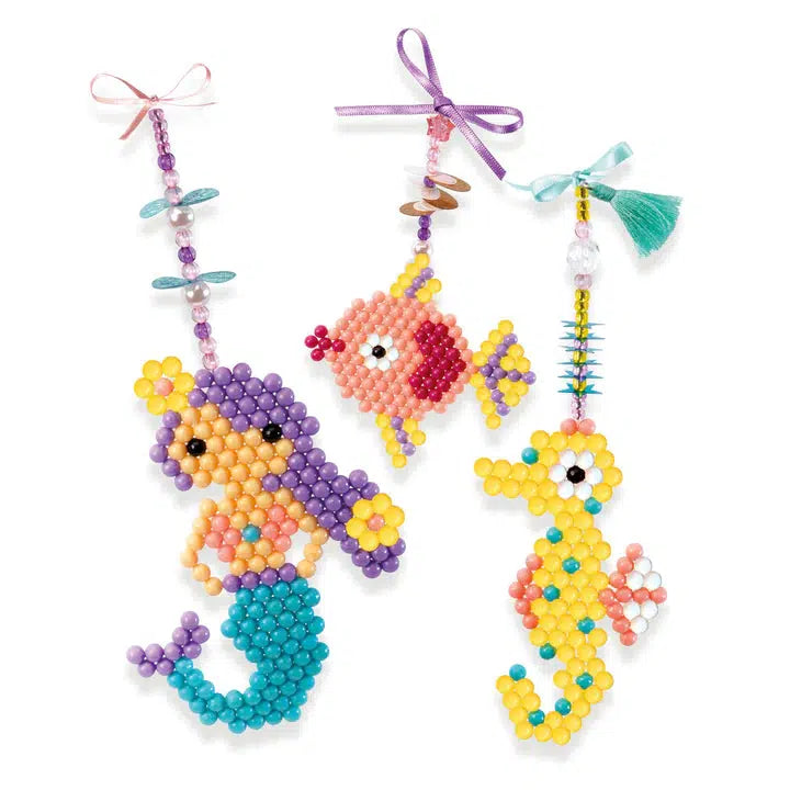 Shows possible finished products. All finished crafts are themed around the ocean with mermaids, fish, and seahorses.