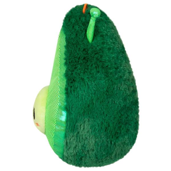 Side view of the plush. Shows that the pit of the avocado sticks out of the front of the plush.