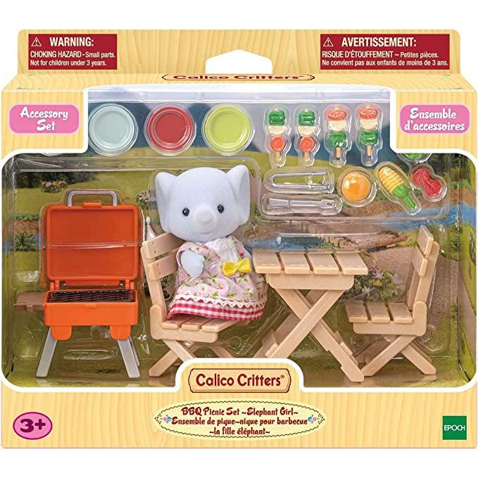 Image of the packaging for the Calico Critters BBQ Picnic with Elephant Girl. The front is made of clear plastic so that you can see all of the individual pieces inside.