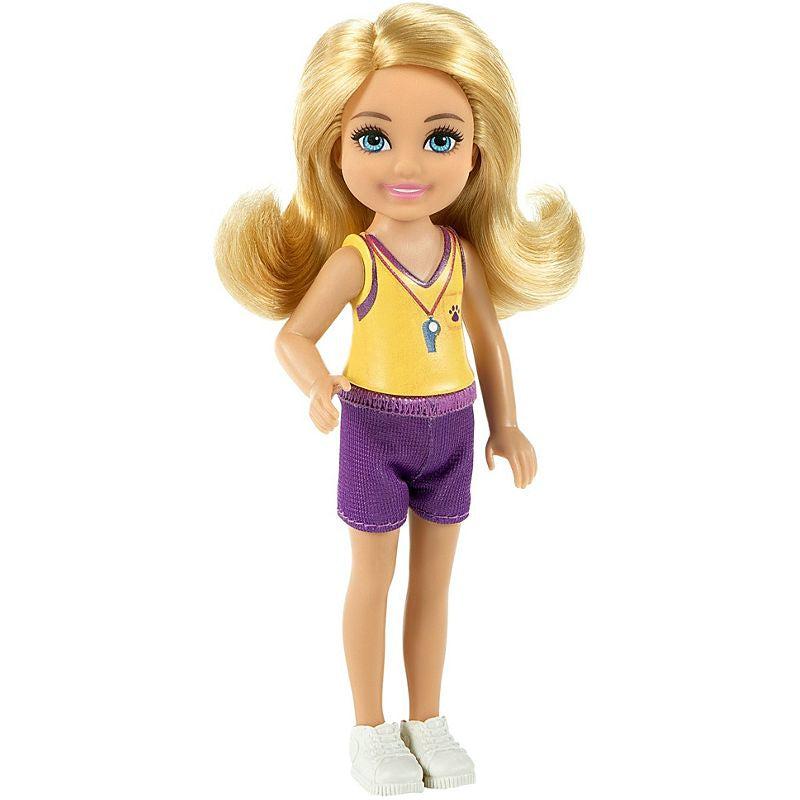 Up close view of the Chelsea doll. She is wearing a yellow and purple outfit that has a whistle around her neck.