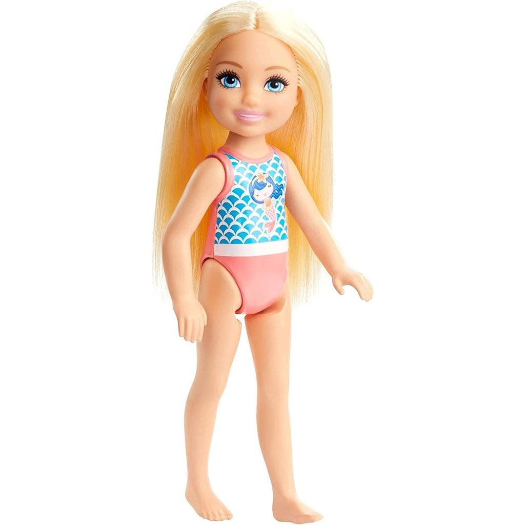 The doll is shown out of the packaging, it has long blond hair down to it's waist and a pink one piece swim suit on that has blue mermaid scale pattern on the front with a graphic of a blue haired mermaid in the middle