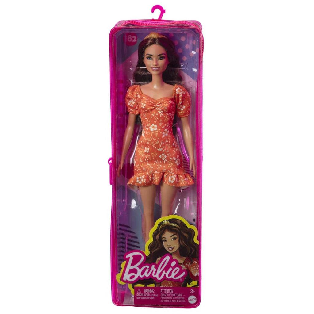 Example doll in package | Doll comes in pink and clear vinyl zipper closure packaging with Barbie logo and doll associated illustration.