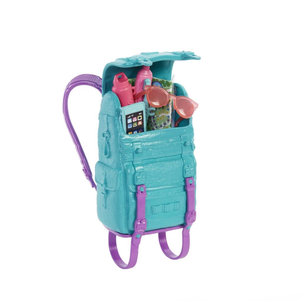 Shows that the backpack can open up to carry many of Barbie's things.