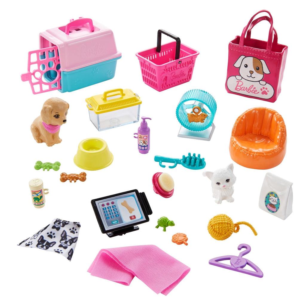 Image of all the smaller pieces included in the set. It includes a dog, a cat, a hamster with a wheel, a set carrier, a shopping basket, a cash register, and various toys and tools to help take care of the animals.