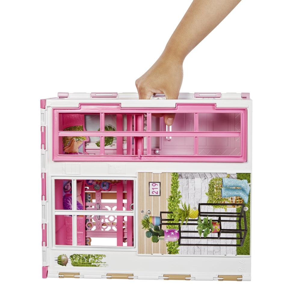 Image of the closed dollhouse. The house has a handle on the top for easy carrying.