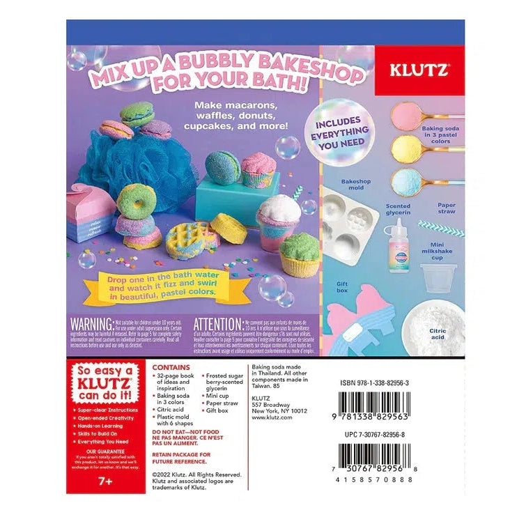 The back of the packaging reads: Mix up a bubbly bakeshop for your bath. Make Macarons, waffles, donuts, cupcakes, and more. Lists the contents that are also in image 2. also reads: Drop one in the bath water and watch it fizz and swirl in beautiful, pastel colors. Lists the contents again at the bottom. It also has a warning label stating contents could be hazardous if eaten by small children.