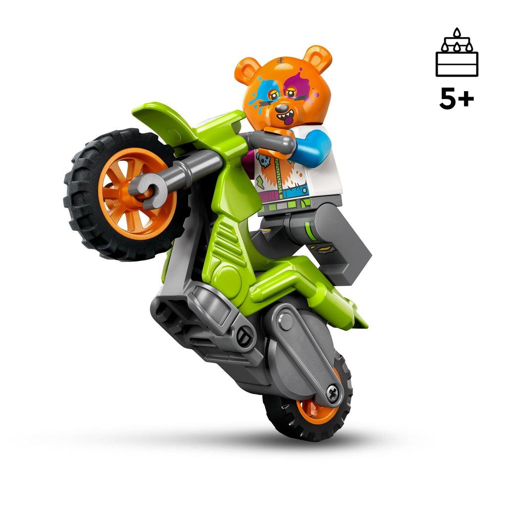 The minifigure is doing a wheelie on the motorcycle | The bear costume is orange with blue and purple splotches of paint over the eyes and a smiling face | age recommendation of 5+ shown in top right