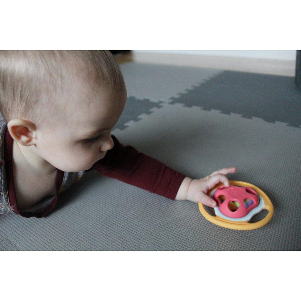 Image of a baby reaching out to hold the toy.