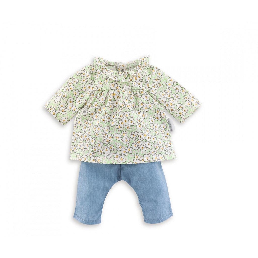 The outfit consists of a green blouse with white flowers printed all over it and a pair of light blue jeans