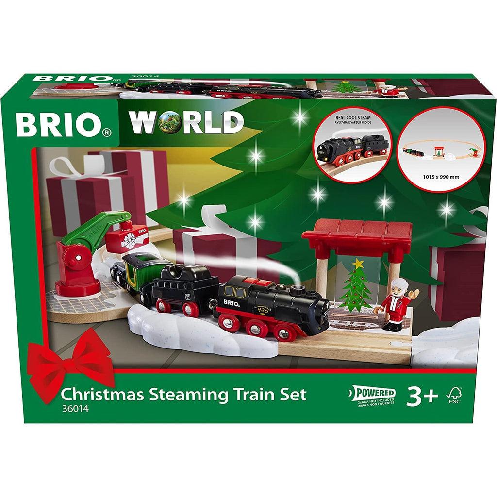 Image is the front of the toy box. It shows a festive border around a close up picture of the train set steaming and delivering a toy to Santa.