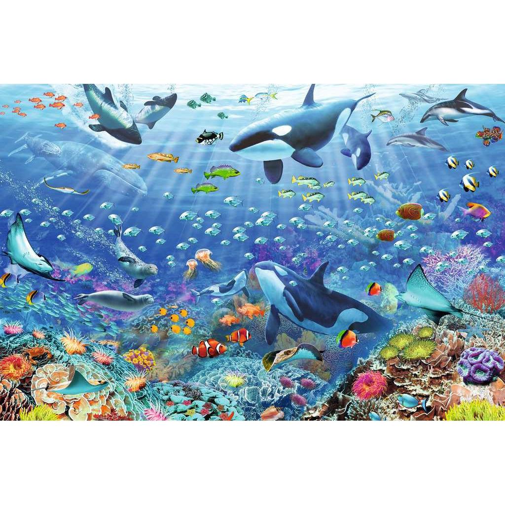 Puzzle image | A colorful coral reef teeming runs along the bottom of the puzzle. Tropical fish swim throughout the reef and open water. | Other ocean life such as whales, seals, jellyfish, manta rays, and more fill the open water.