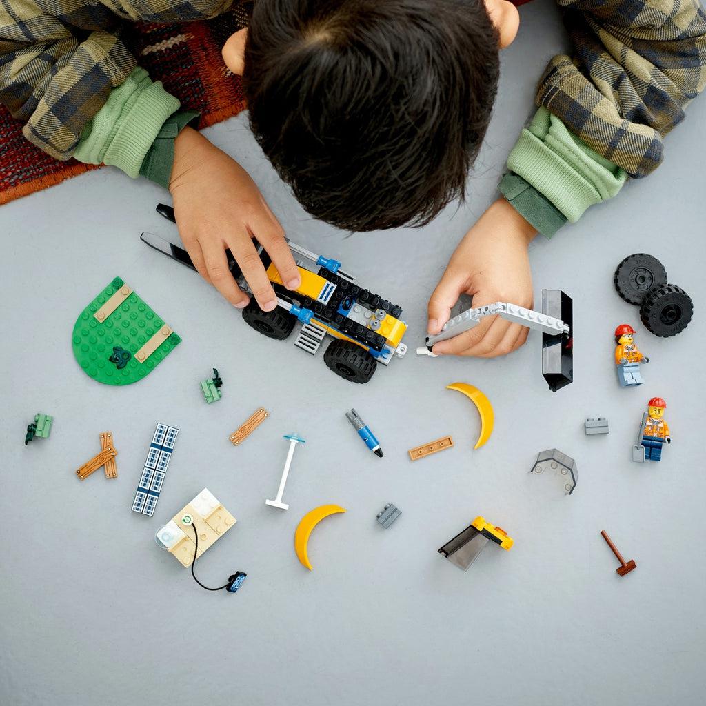 a child is shown halfway through building the lego set