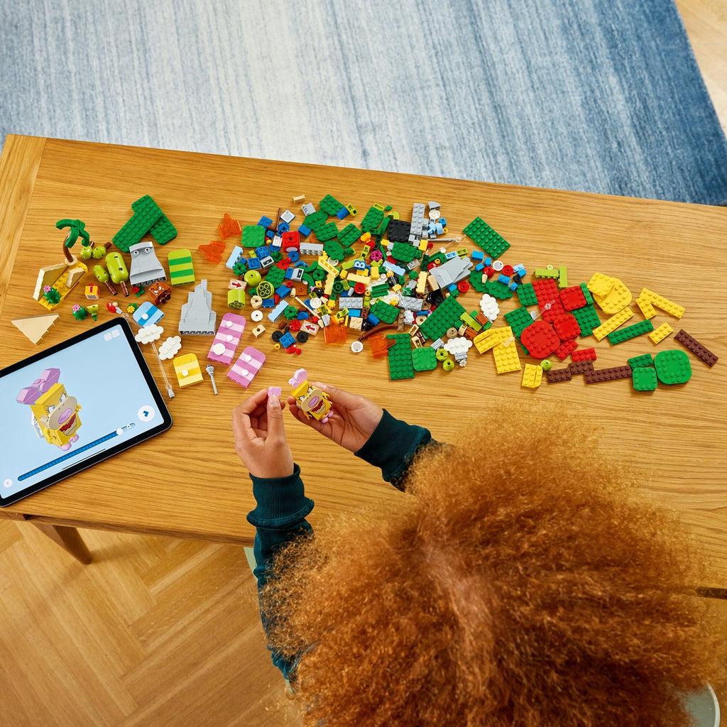 a girl is using the lego builder app for instructions to build the lego set