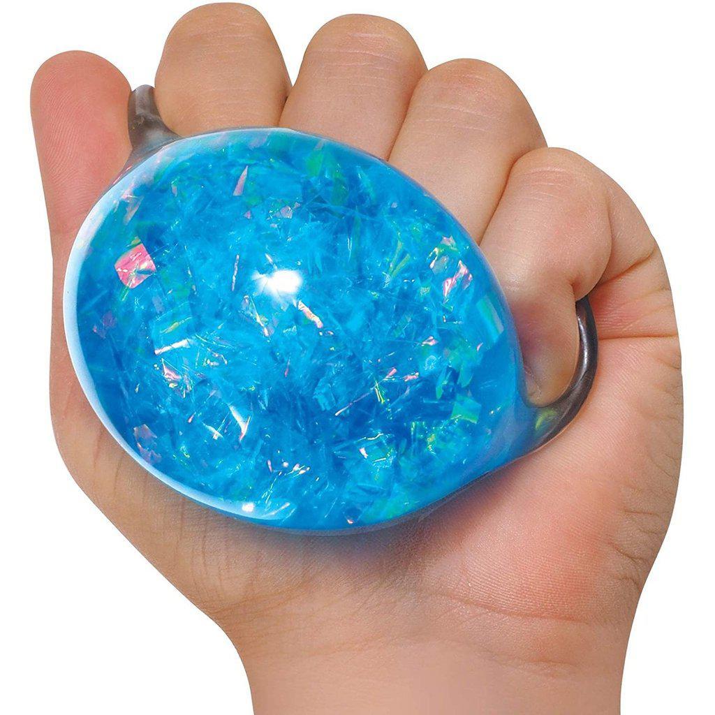 a hand squishes a blue crystal squeeze needoh