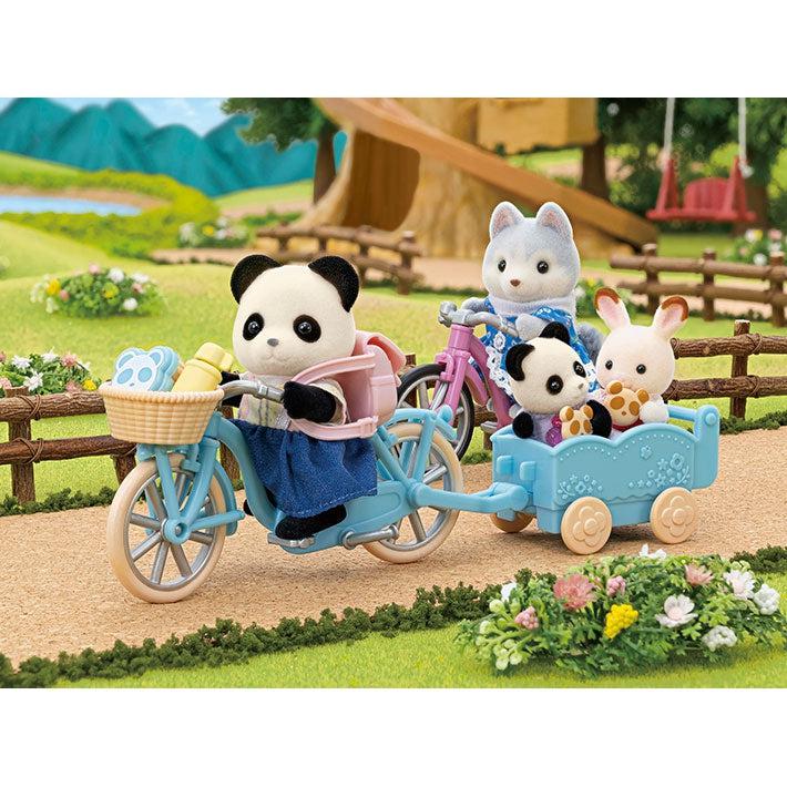 Scene of the panda girl riding her bike with her wolf friend while pulling two children critters in the wagon.