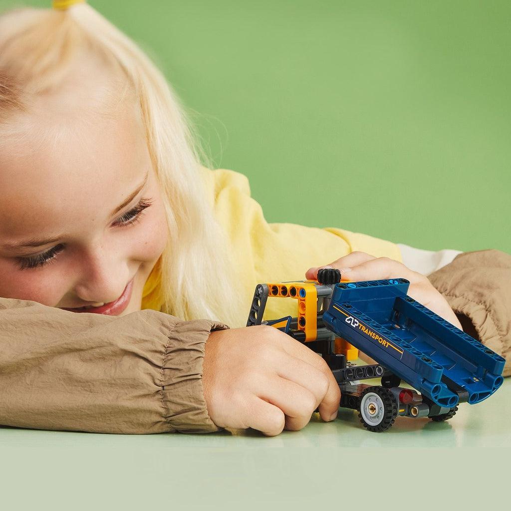 a child is playing with the lego set on a table