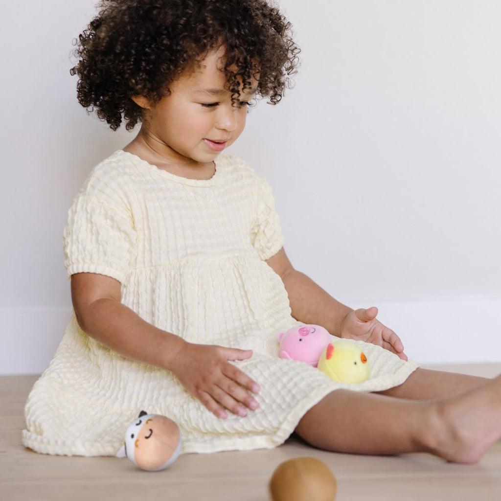 Young toddler sitting on floor playing with toys