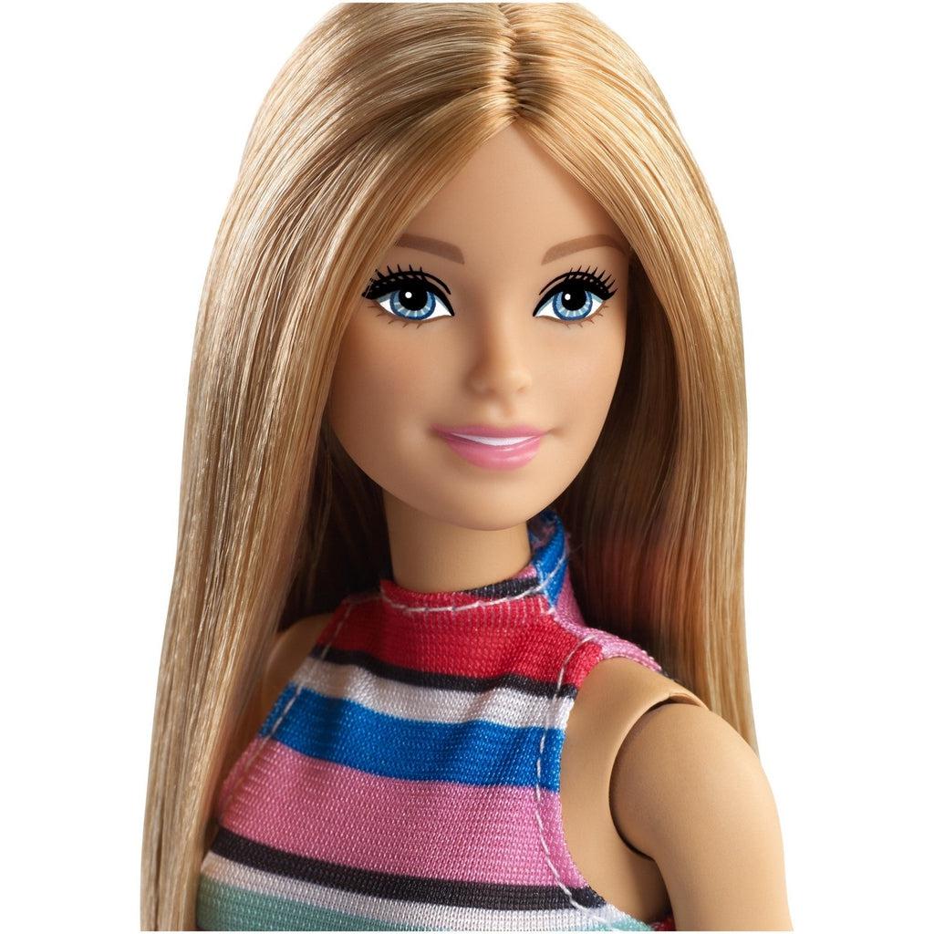 Close up of Barbie's face | She has blonde hair, blue eyes, and light pink lips. 