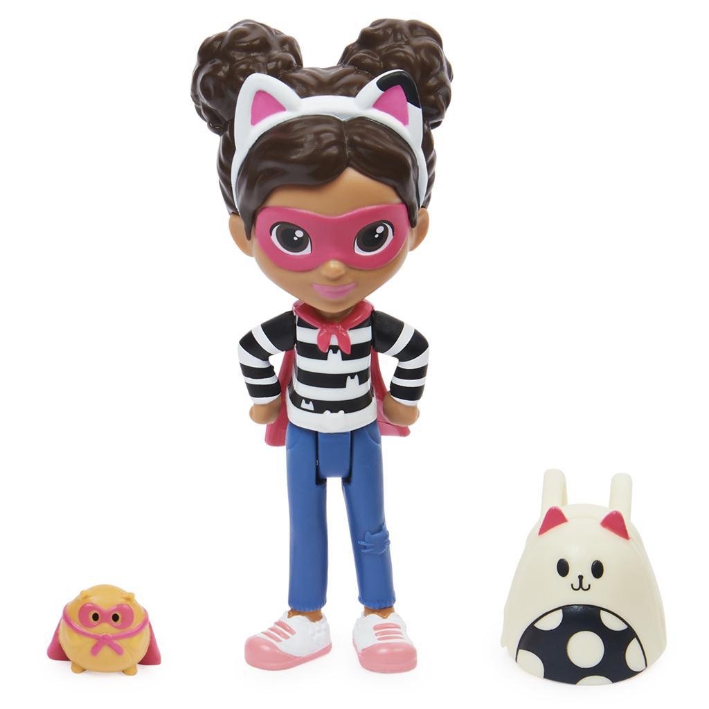 Doll and accessories out of packaging | Includes: Gabby doll in black/white stripe shirt, blue pants, sneakers, her cat headband and a super hero cape and mask. | Small hamster doll in matching cape and mask. | Gabby white cat backpack with black and white polka dot detail.