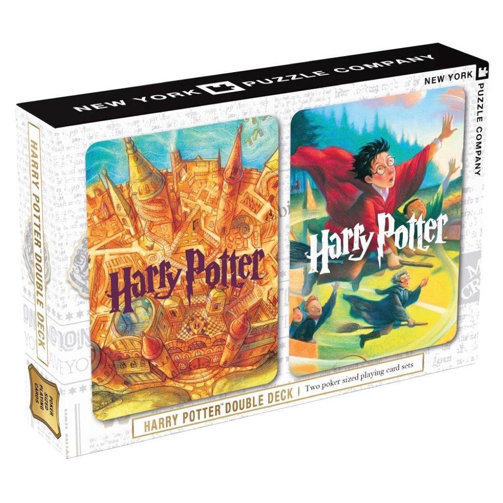 Image of the packaging for the Harry Potter Double Deck Playing Cards. On the front of the box is a picture of the back illustration for both decks. One deck is an illustration of Hogwarts, and the other is of Harry Potter on a broom during a quidditch match.
