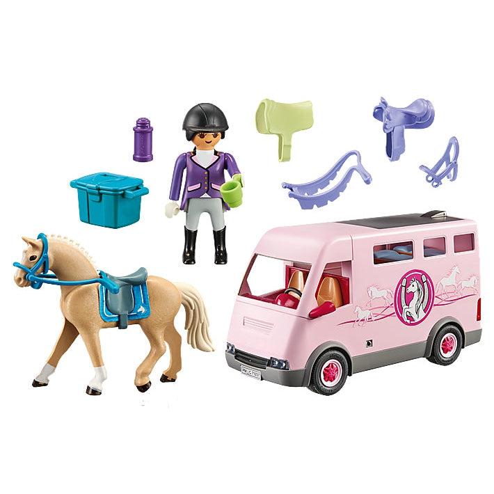 The horse, rider, and accessories are shown next to the large pink horse transport van with a darker pink logo on the side with an image of a horse rearing