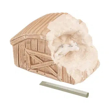 Image of toy | Small brown plaster barn partially broken open to reveal small plastic cow figurine stuck inside. | Included chisel is shown off to the side.