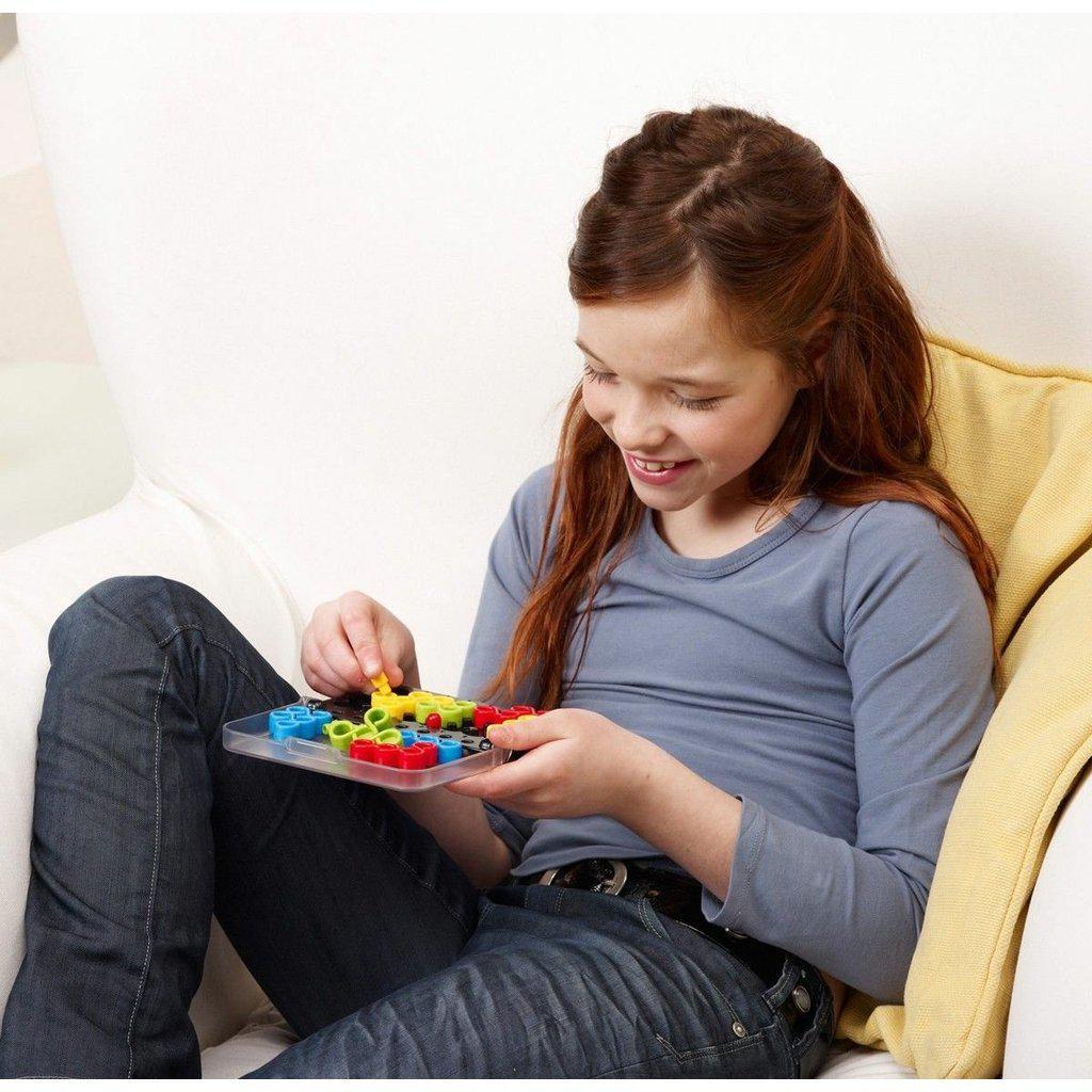 a young girl smiles while playing the game 
