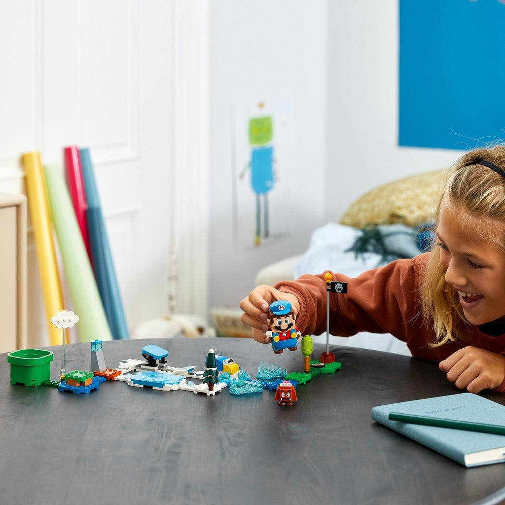 a girl is playing with this lego set that has been combined and connected to the lego super mario starter set