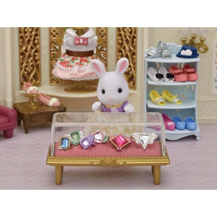 Scene of the rabbit keeping all of her jewelry inside of the golden display case.