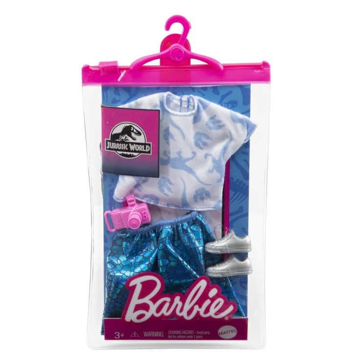 First pack contains a white t-shirt with blue raptors on it, a blue scale pattern skirt, a pink plastic camera, and silver tennis shoes.