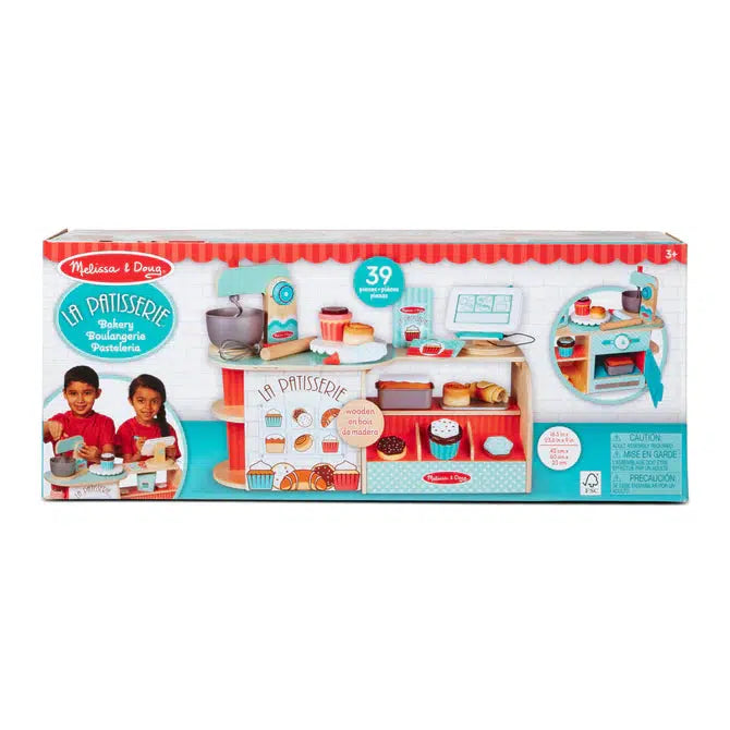 Image of the packaging for the La Patisserie Bake Shop. The front of the box has a picture of the fully put together and stocked shop. It also has a picture of two kids smiling while creating treats and using the cash register.