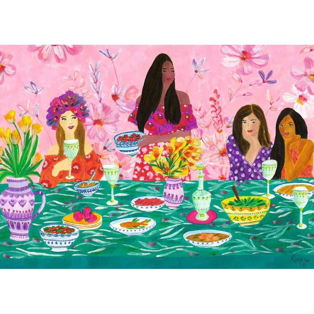 Puzzle is of a stylized illustration. Four diverse women in colorful dresses sit at a green clothed table to enjoy brunch together. Behind them is a pink floral print background.
