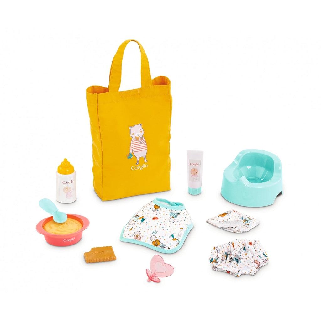 The items included are all displayed, included is a bib with bear characters printed on it, a pacifier shaped like a heart, a bowl and spoon, a bottle, a potty, cloth diaper and a cloth wipe, both with the same pattern as the bib, and a bag to carry it all in.