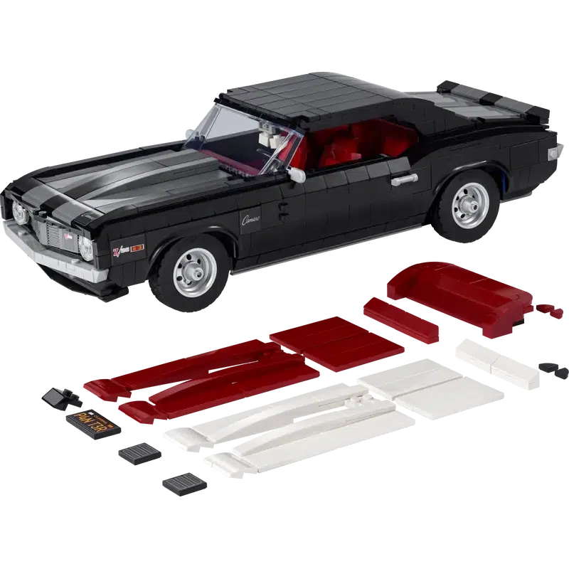 The car is shown from the left side with the red and white stripe blocks for replacing the racing stripes are placed in front of it. | the back seats head rest extension is also shown for use when removing the top to display it as a convertible.