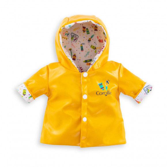 One side of this reversible rain coat is shown. It's styled mainly like a classic yellow rubber raincoat with white buttons. The interior and the wrist cuffs have a pattern of art supplies printed all over it.