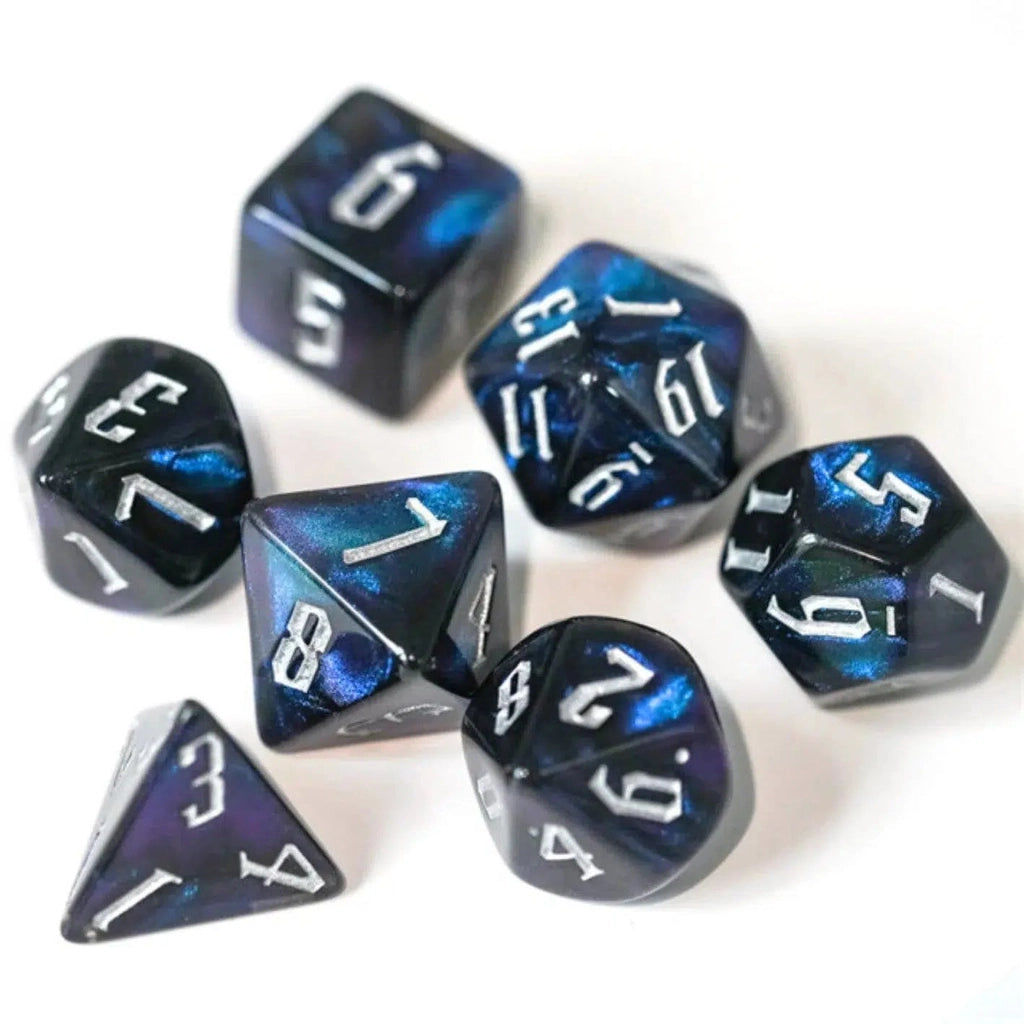 All 7 dice are shown. They are made of black resin with swirls of blue and purple swished around and visible on the surface of the dice.