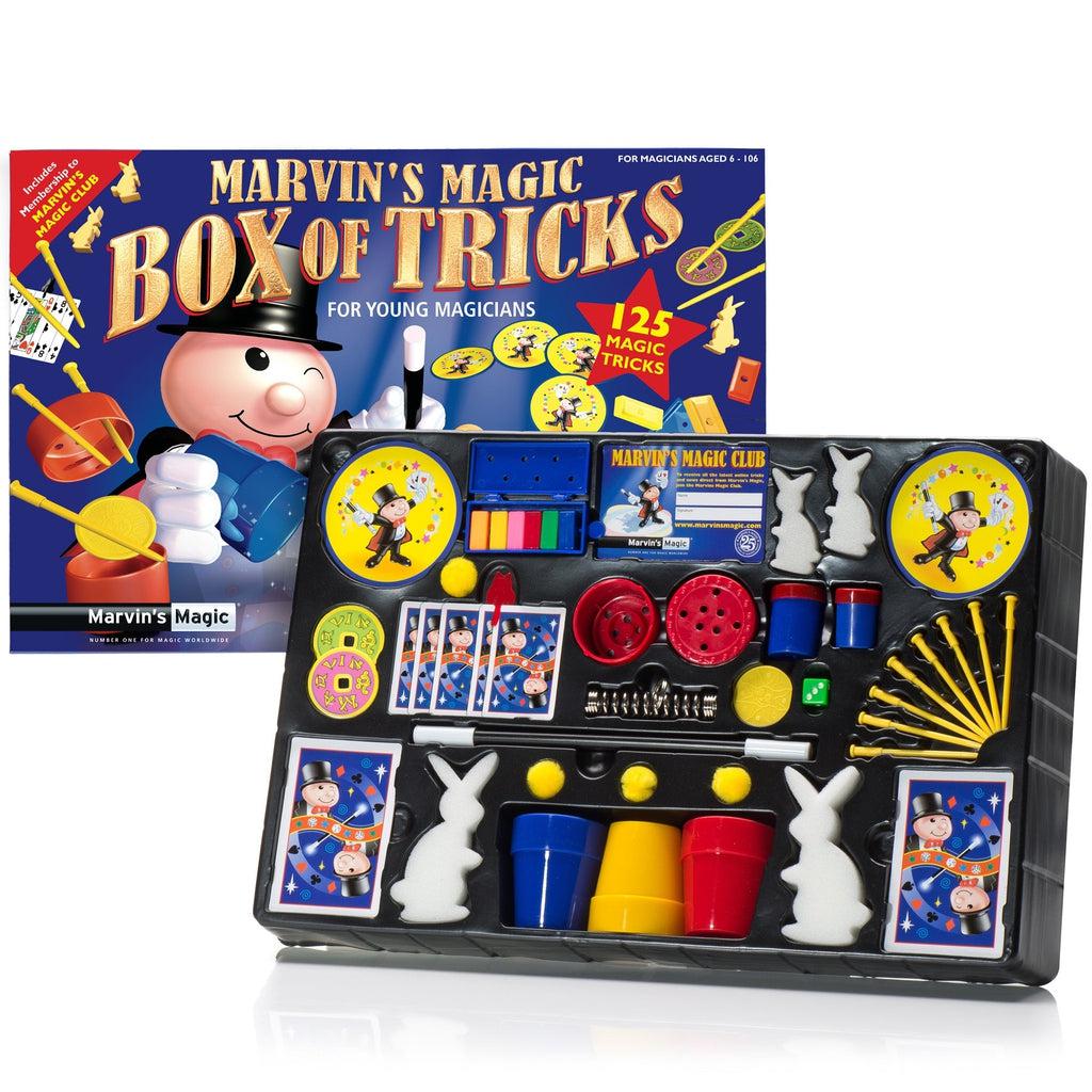 The inside of the box is shown revealing the contents. There are multiple bunny figuines of various sizes, 3 cups and 4 balls, 7 pins, lots of playing cards for magic, a wand, a spring, and other various tools for tricks. 