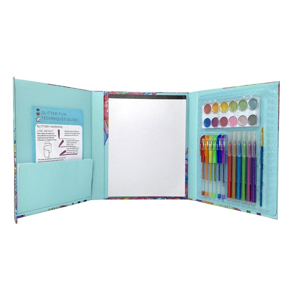this image shows the art pack opened up, showing the inside is like a folder in three parts, the left with the guide, center with the paper, and right with the pens and paint