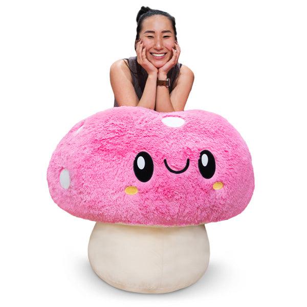 Image of the Massive Mushroom squishable. It is a very large pink mushroom with a cute face and white spots.