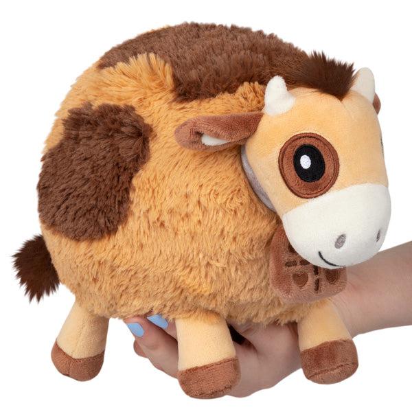 Image of the Mini Chocolate Cow squishable. It is a brown cow with darker brown spots.