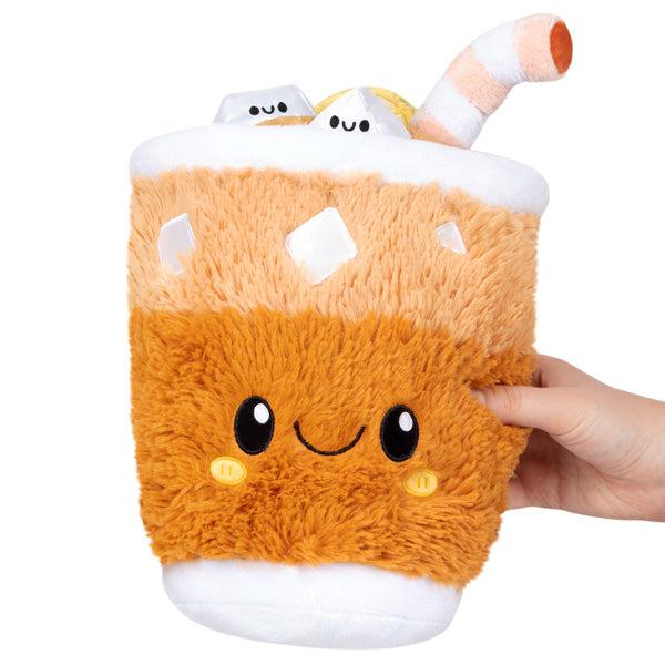 Image of the Mini Iced Tea squishable. It is a fluffy iced tea drink plush with a cute face, ice cubes, and a straw.