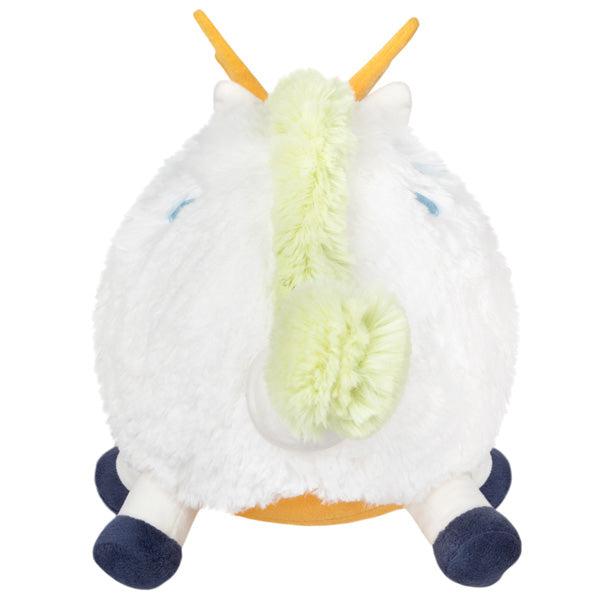 Back view of the plush. Shows that it has a yellow lizard/dragon body and a light yellowish-green mane and tail.