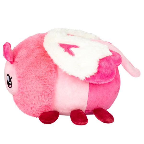 Side view of the plush. Shows that there are pink hearts on the white wings.