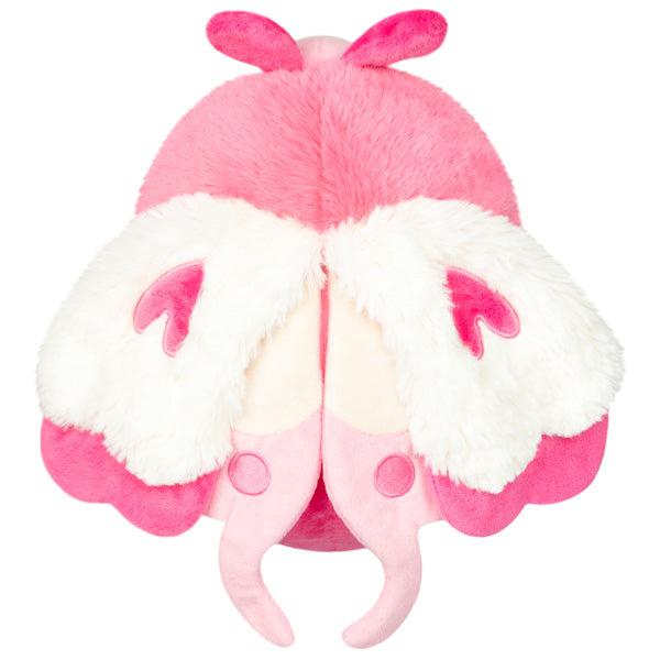 Top view of the plush. Shows that it has two sets of wings. The entire plush is completely colored pink and white.