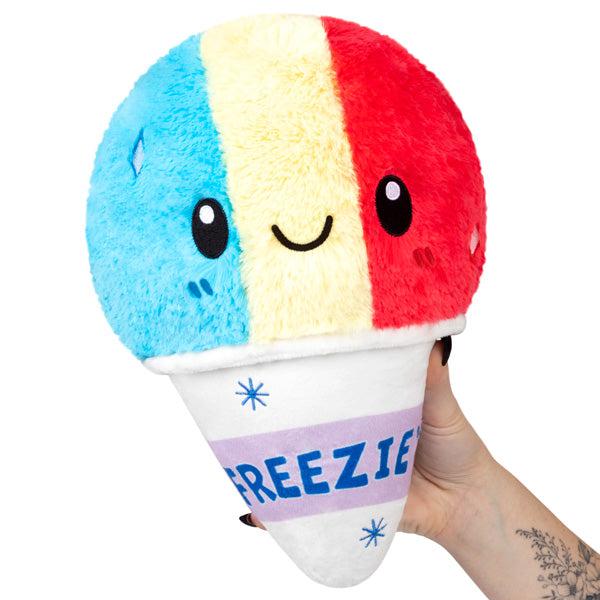 Image of the Mini Shaved Ice squishable. It is a tri-colored (blue, white, and red) snow cone plush.